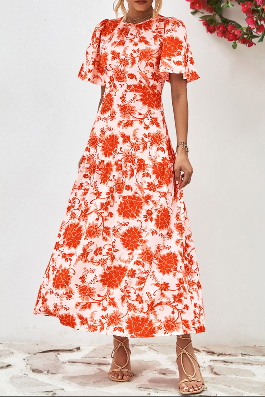 Orange Floral Print Knotted Back Round Neck Maxi Dress• Embrace the vibrant energy of summer with this dress, featuring a charming knotted back detail for a touch of elegance.
• Effortlessly chic, this dress boasts a r