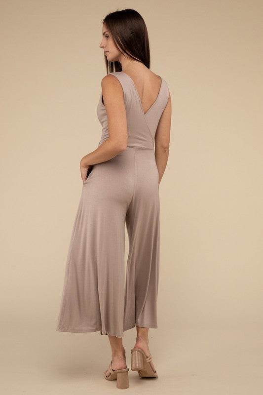 Surplice Neckline Sleeveless JumpsuitThe Surplice Neckline Sleeveless Jumpsuit exudes effortless elegance and modern sophistication. Featuring a surplice neckline, this jumpsuit offers a chic and flatte