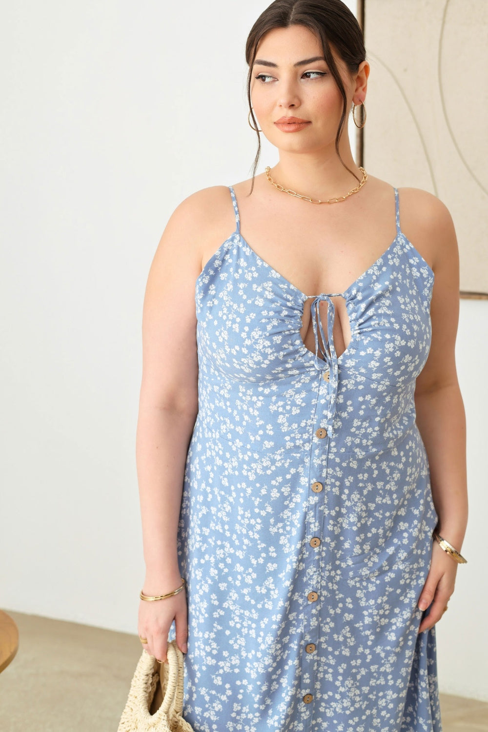 Zenobia Plus Size Cutout Floral Spaghetti Strap DressCutout Floral Spaghetti Strap Dress is a stylish and feminine piece that is perfect for summer outings or special occasions. The cutout design adds a trendy touch, w