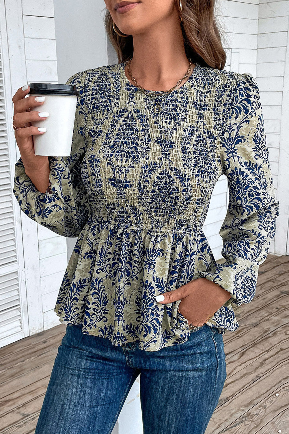 Sky Blue Ethnic Print Balloon Sleeve Smocked Peplum BlouseMaterial:100%Polyester

• Elevate your bohemian style with our blouse, featuring intricate ruffle details for a touch of whimsy.
• The shirred design creates a fla