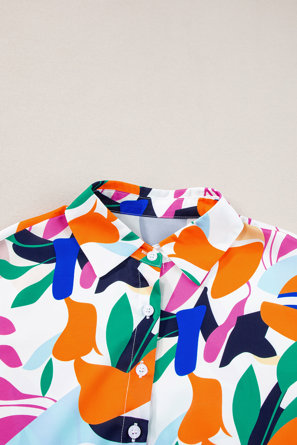 Multicolour Abstract Leaf Print Button Up Short Sleeve BlouseMaterial:100%Polyester

• Infuse your wardrobe with vibrancy in this blouse, perfect for a relaxed yet stylish look.
• The button-up design adds a touch of sophist