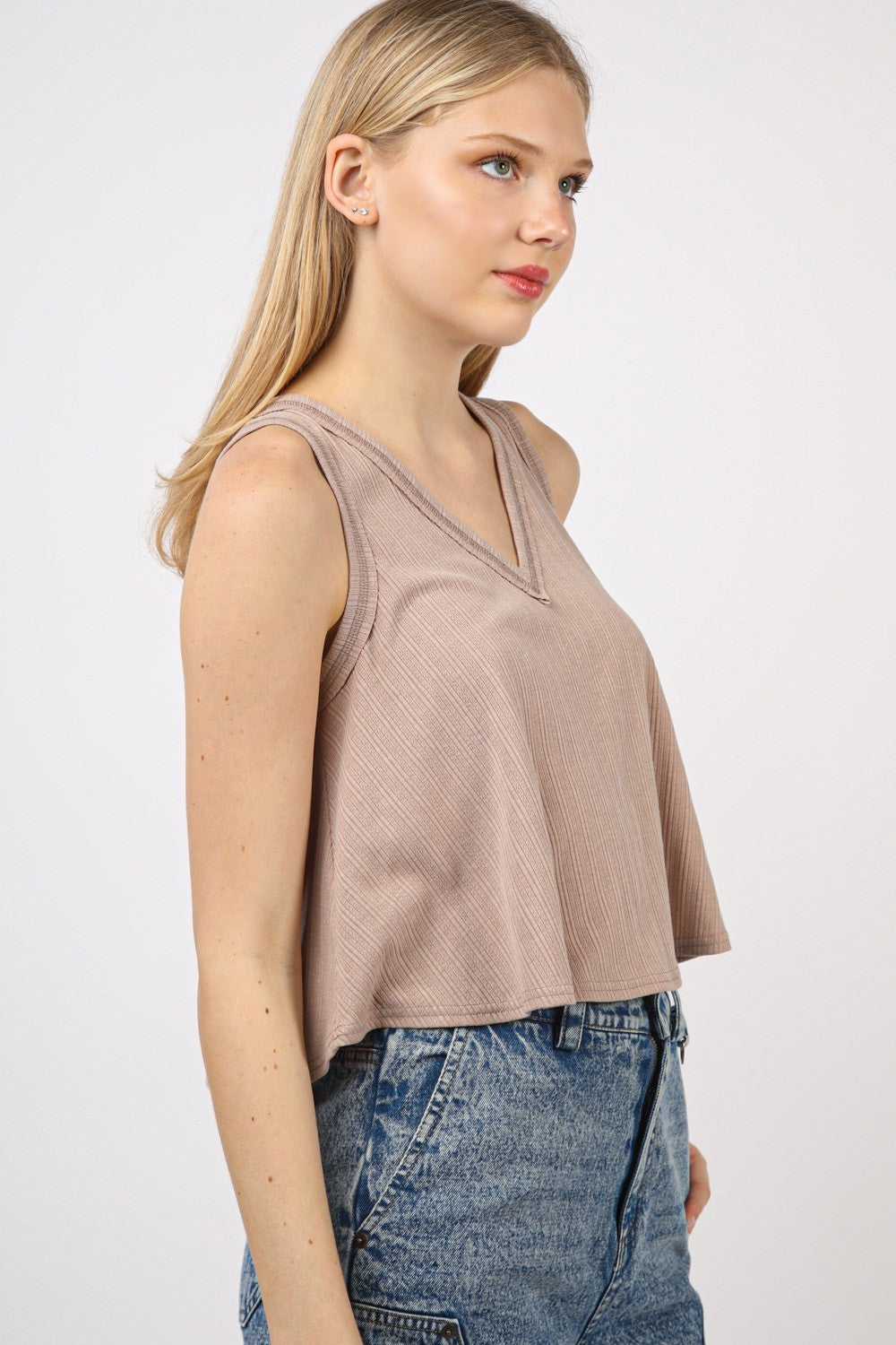 VERY J V-Neck Knit Swing Cropped TankLook effortlessly chic in this Sleeveless Soft Knit Swing Crop Top featuring raw edge detail, designed to add a touch of casual charm to your outfit. This soft girlc