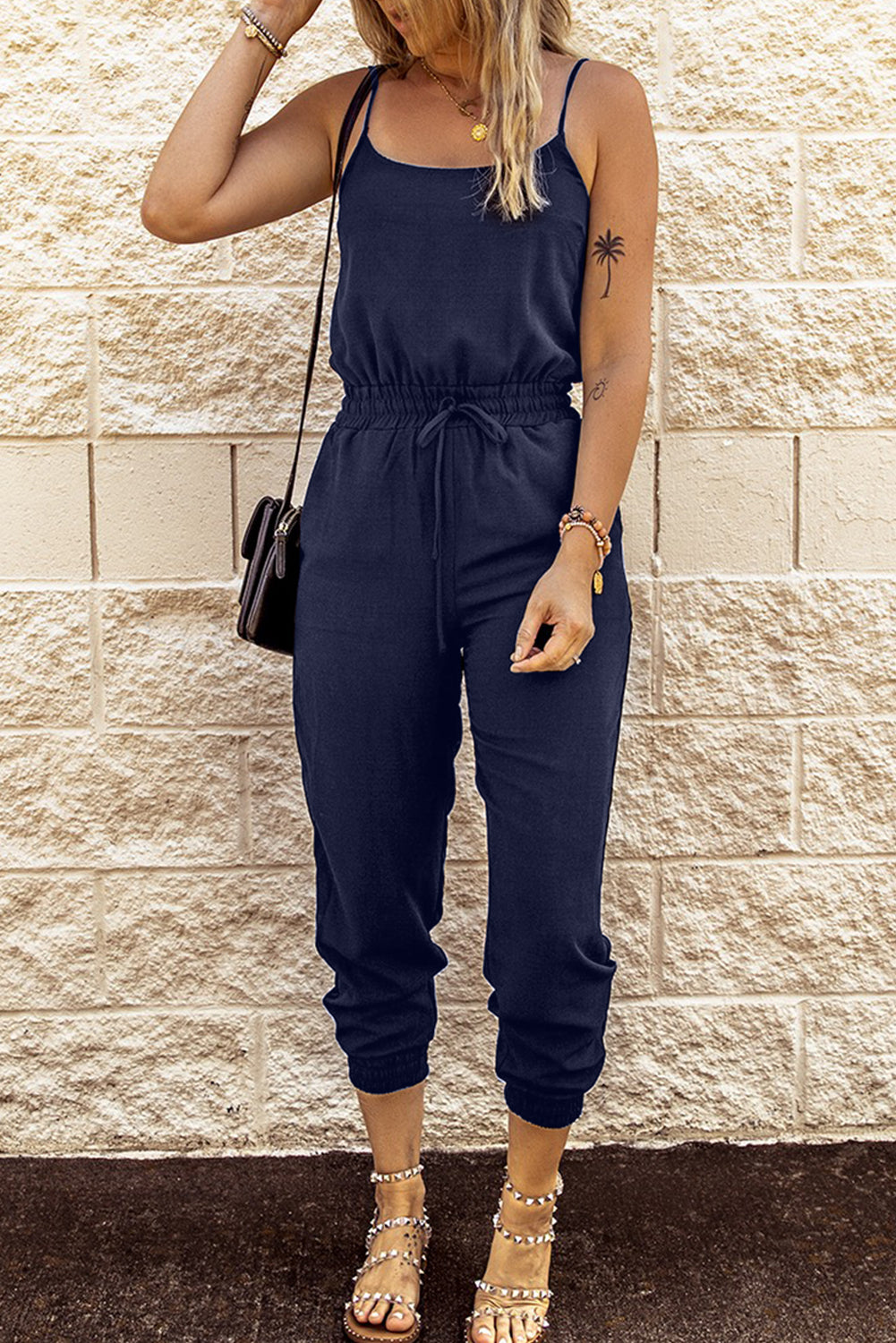 Dark Blue Pockets Drawstring Waist Spaghetti Strap JumpsuitMaterial:95%POLYESTER+5%ELASTANE



		An amazing jumpsuit to make customers feel chic and slim
	
	
		Spaghetti straps design is flirty and sexy
	
	
		Flatter