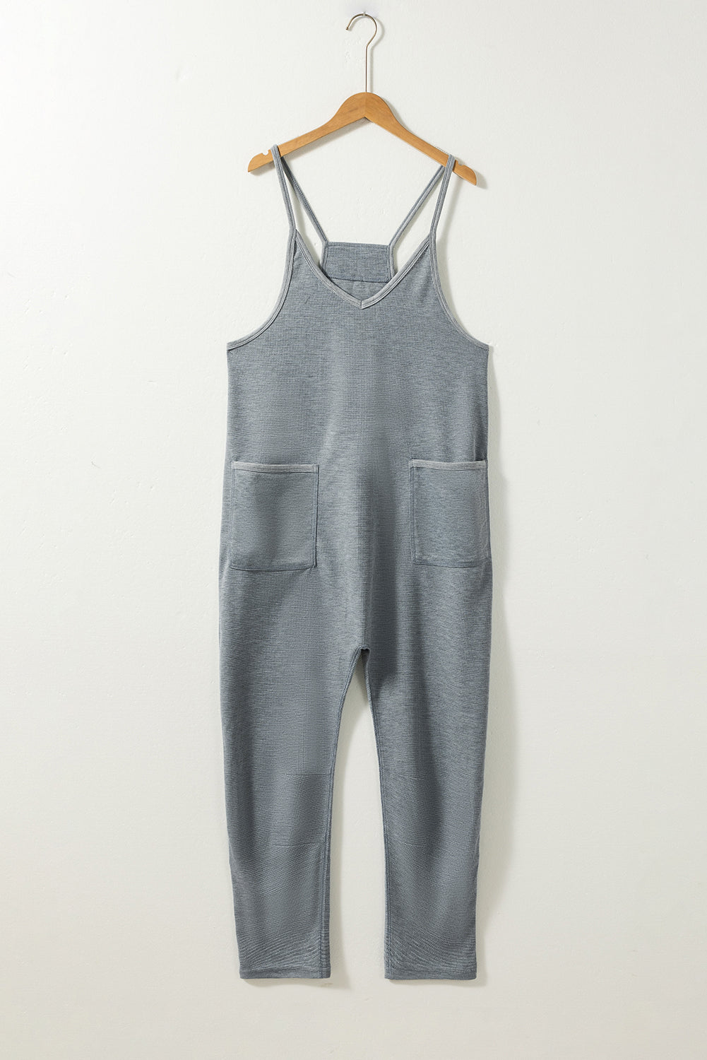 Gray Waffle Knit Spaghetti Strap Pocketed JumpsuitMaterial:95%POLYESTER+5%ELASTANE



		This jumpsuit features delicate spaghetti straps, which give it a feminine and summery look. 
	
	
		The thin straps allow 