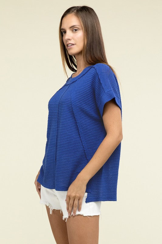 Brushed Waffle Exposed-Seam Short Sleeve TopElevate your casual wardrobe with this Brushed Waffle Top, featuring side slits, exposed seam details, and a stylish hi-low hem. Perfect for a relaxed yet trendy loo