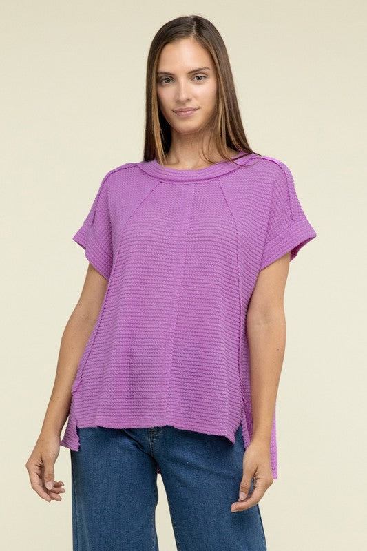 Brushed Waffle Exposed-Seam Short Sleeve TopElevate your casual wardrobe with this Brushed Waffle Top, featuring side slits, exposed seam details, and a stylish hi-low hem. Perfect for a relaxed yet trendy loo