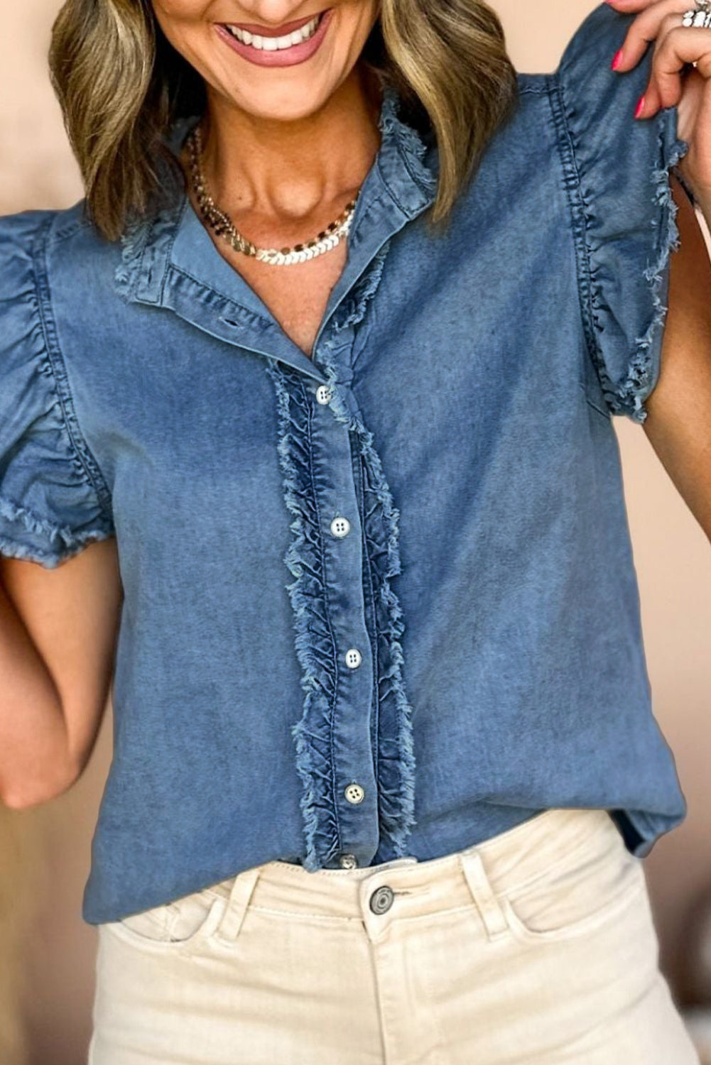 Beau Blue Button Front Ruffled Flutter Frayed Denim TopMaterial:100%Cotton



		The ruffled flutter sleeves create a playful and flirty look, adding movement and charm to the overall design.
	
	
		The frayed detaili