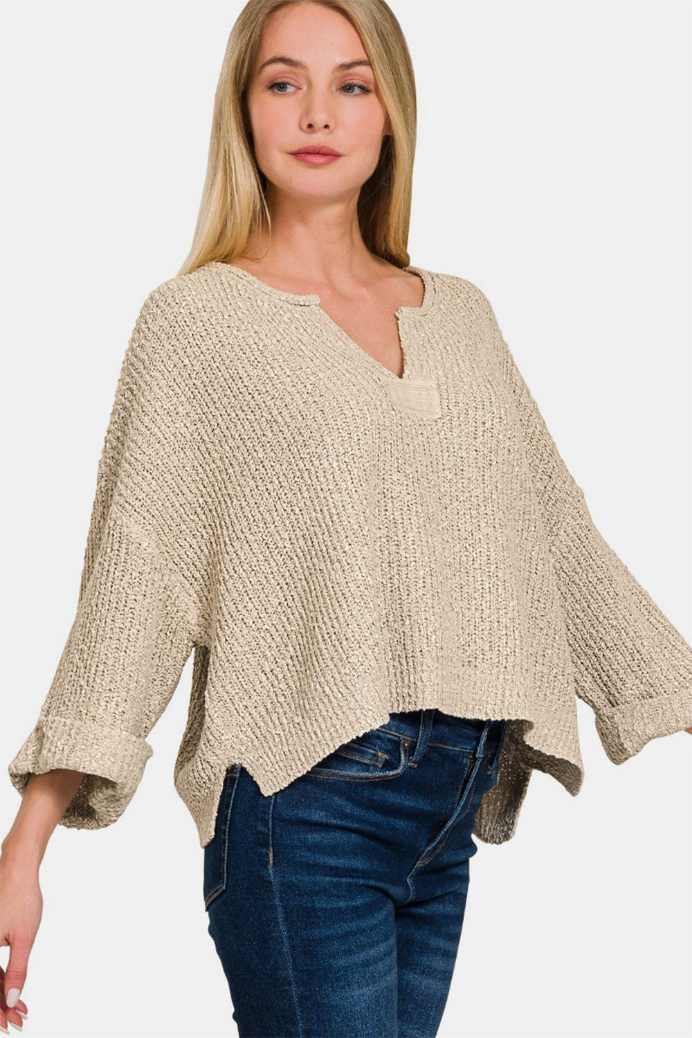 Zenana Notched Side Slit Patch SweaterThe notched side slit patch sweater is a trendy and unique addition to your knitwear collection. With its stylish notched design and side slits, this sweater adds a 