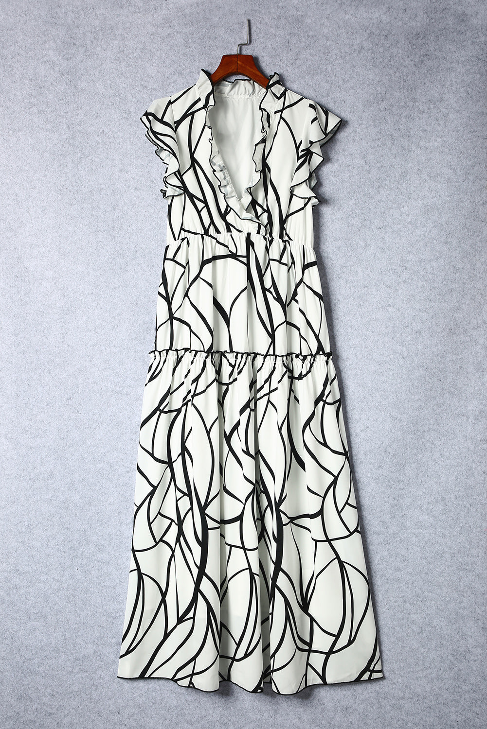 White Abstract Print V Neck Ruffle Maxi DressMaterial:100%Polyester



		The dress has a V-neckline, which adds a touch of femininity to the overall look. 
	
	
		It also has ruffle details on the shoulders