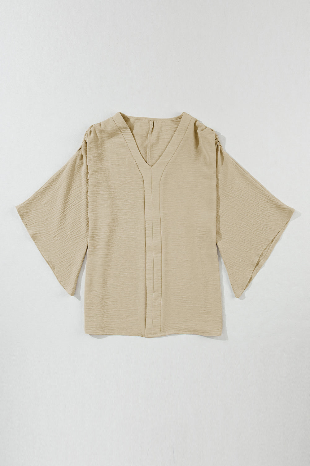 Parchment Solid Color Crinkled V Neck Ruffled Sleeve BlouseMaterial:100%Polyester



		The blouse comes in a solid color, which provides a clean and versatile look. 
	
	
		The crinkled effect also makes the blouse resis