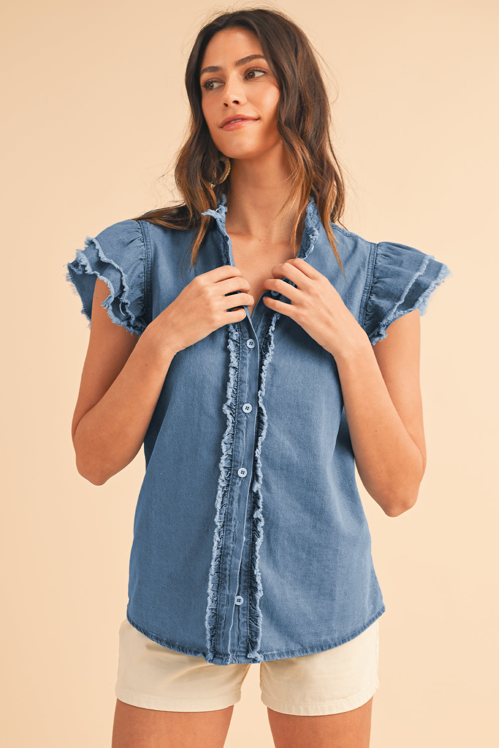 Beau Blue Button Front Ruffled Flutter Frayed Denim TopMaterial:100%Cotton



		The ruffled flutter sleeves create a playful and flirty look, adding movement and charm to the overall design.
	
	
		The frayed detaili