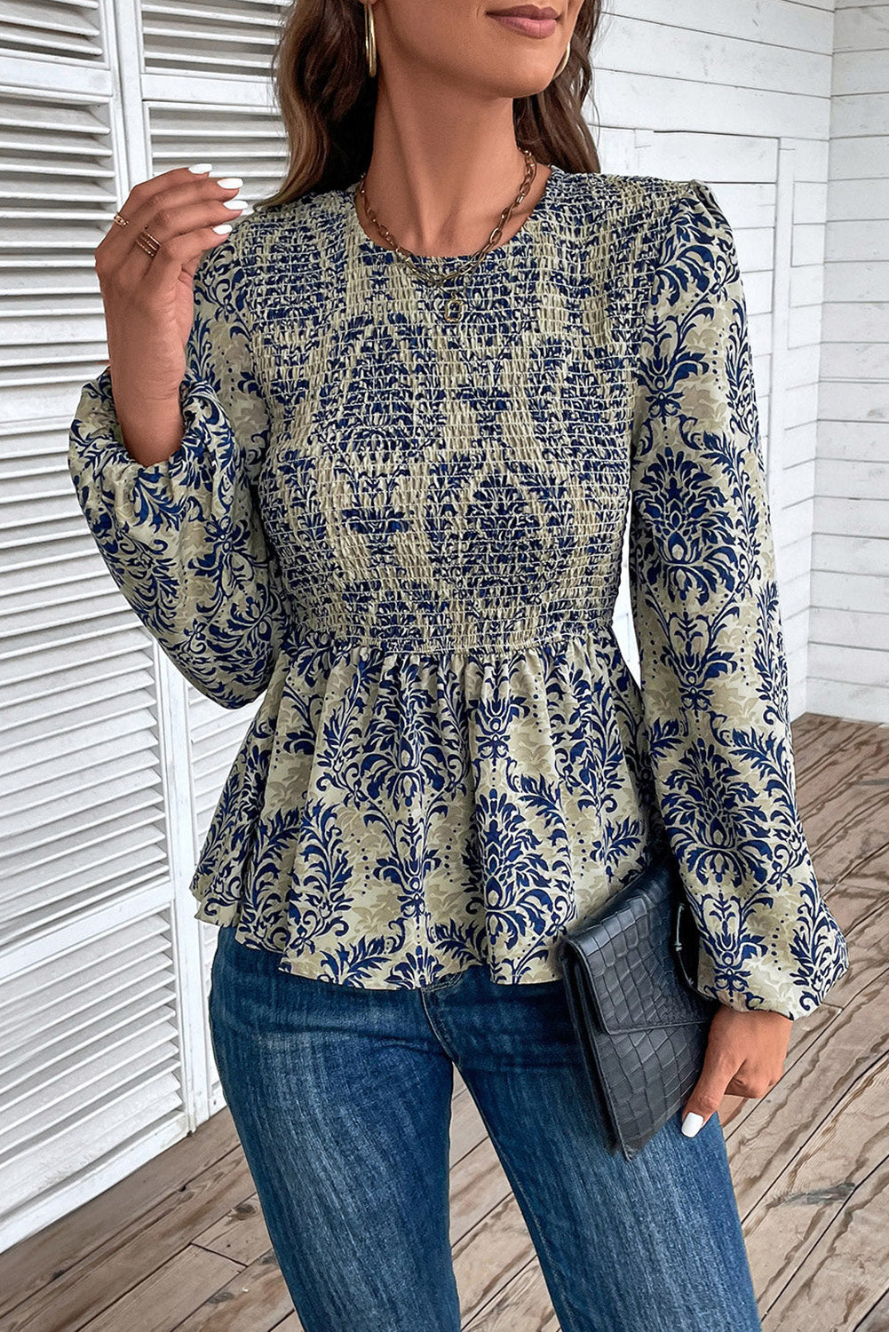 Sky Blue Ethnic Print Balloon Sleeve Smocked Peplum BlouseMaterial:100%Polyester

• Elevate your bohemian style with our blouse, featuring intricate ruffle details for a touch of whimsy.
• The shirred design creates a fla