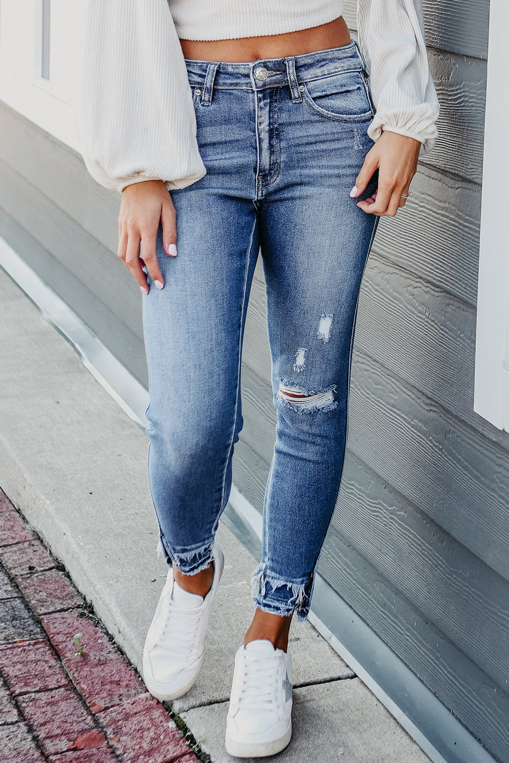 Light Blue Distressed Hem Cropped Skinny JeansMaterial:66%Cotton+27%Polyester+6%Lyocell+1%Elastane



		The ankle skinny jeans feature stylish ripped details, adding a trendy and edgy touch to the overall look