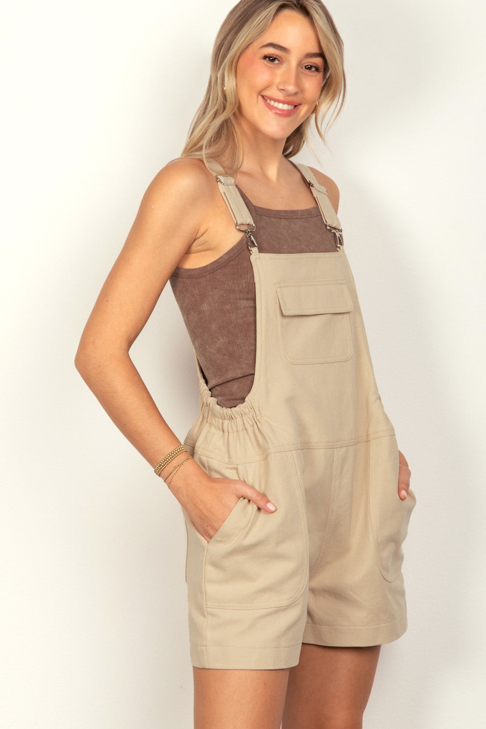 VERY J Adjustable Suspender Overalls with PocketsThe versatile Suspender Solid Woven Casual Overall Romper features front and side pockets for added functionality. The elastic waist ensures a comfortable and adjust