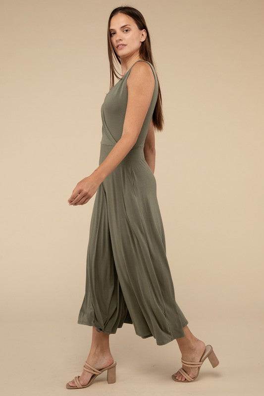 Surplice Neckline Sleeveless JumpsuitThe Surplice Neckline Sleeveless Jumpsuit exudes effortless elegance and modern sophistication. Featuring a surplice neckline, this jumpsuit offers a chic and flatte