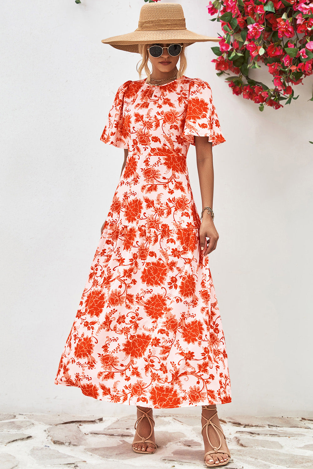 Orange Floral Print Knotted Back Round Neck Maxi Dress• Embrace the vibrant energy of summer with this dress, featuring a charming knotted back detail for a touch of elegance.
• Effortlessly chic, this dress boasts a r