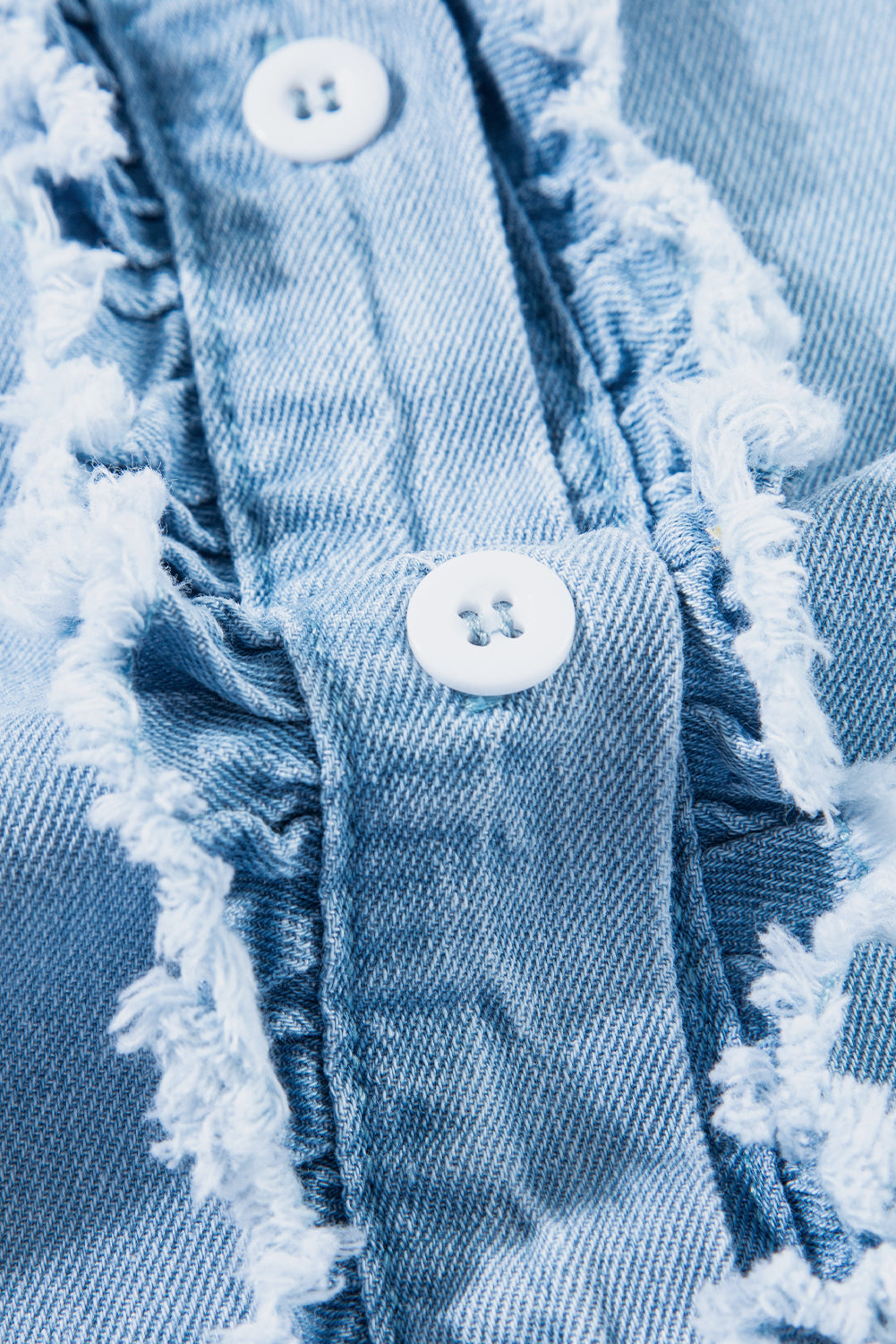 Beau Blue Button Front Ruffled Flutter Frayed Denim TopMaterial:100%Cotton



		The ruffled flutter sleeves create a playful and flirty look, adding movement and charm to the overall design.
	
	
		The frayed detaili