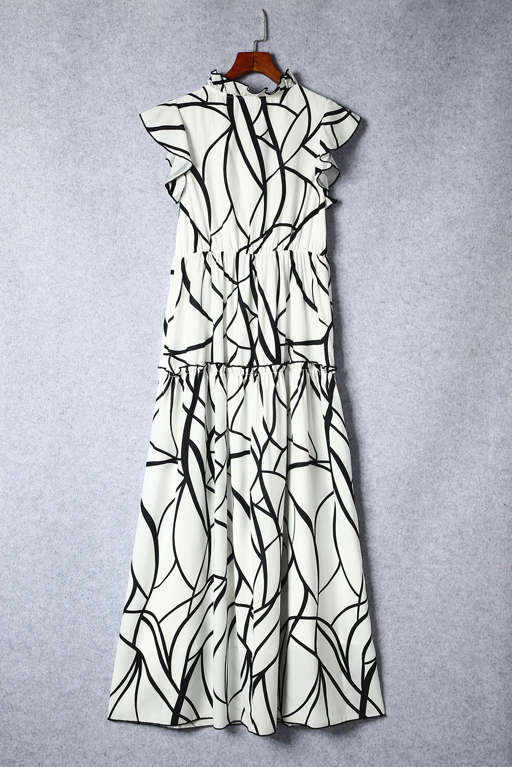 White Abstract Print V Neck Ruffle Maxi DressMaterial:100%Polyester



		The dress has a V-neckline, which adds a touch of femininity to the overall look. 
	
	
		It also has ruffle details on the shoulders