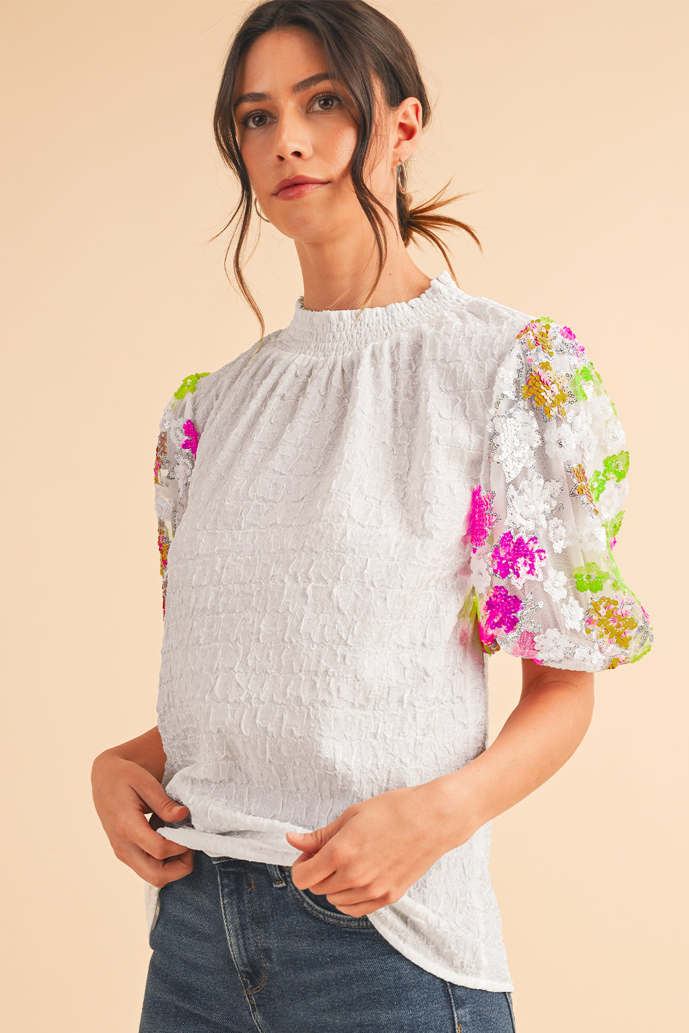 White Smocked Neck Sequin Flower Puff Sleeve Textured TopMaterial:100%Polyester



		The Top features a smocked neckline and sequin flower embellishments for a feminine and glamorous look.
	
	
		With its puff sleeves,