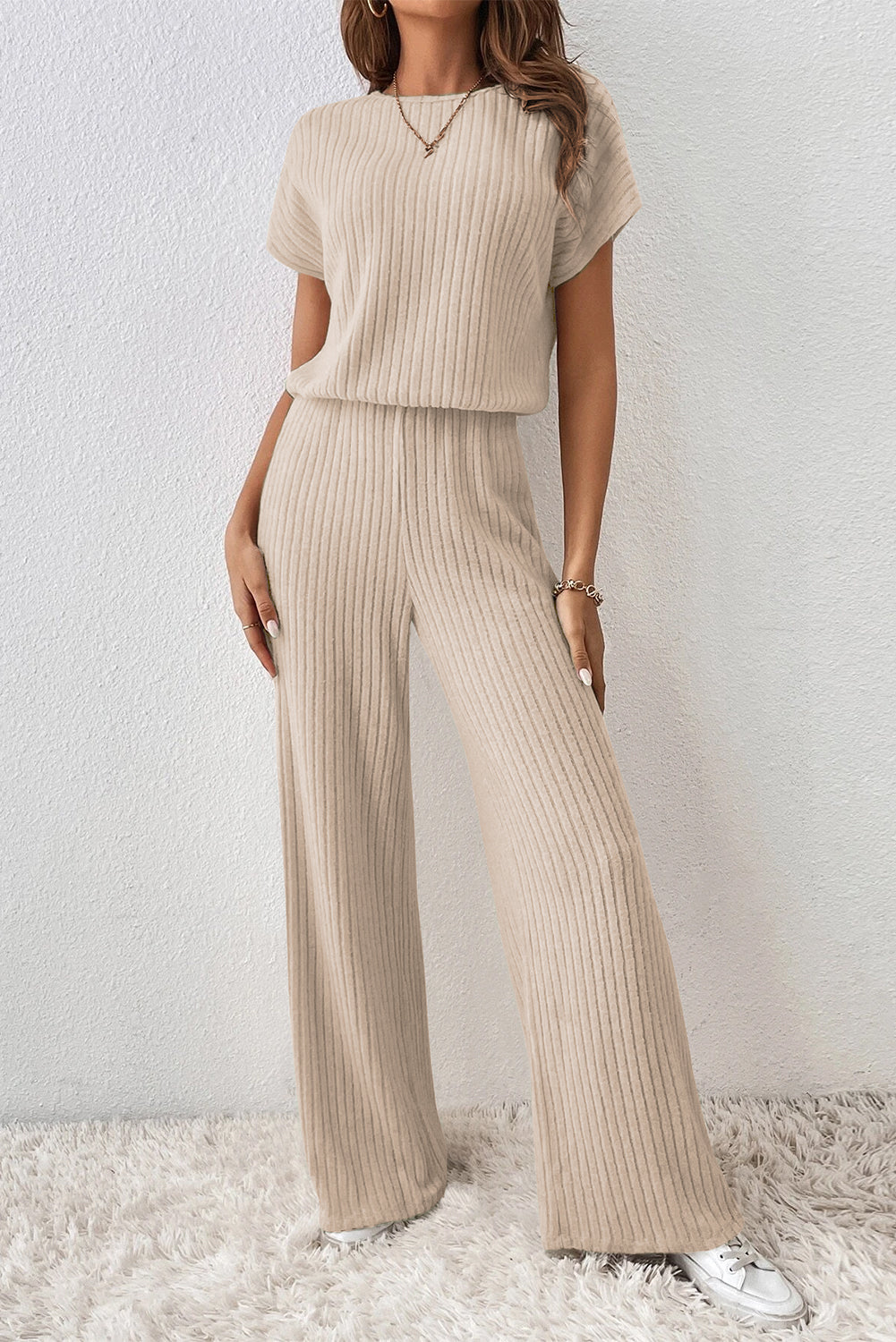 Grass Green Solid Color Ribbed Short Sleeve Wide Leg JumpsuitMaterial:85%Polyester+10%Viscose+5%Elastane



		The jumpsuit is a versatile and trendy one-piece outfit, featuring a solid color design that offers a sleek and mi