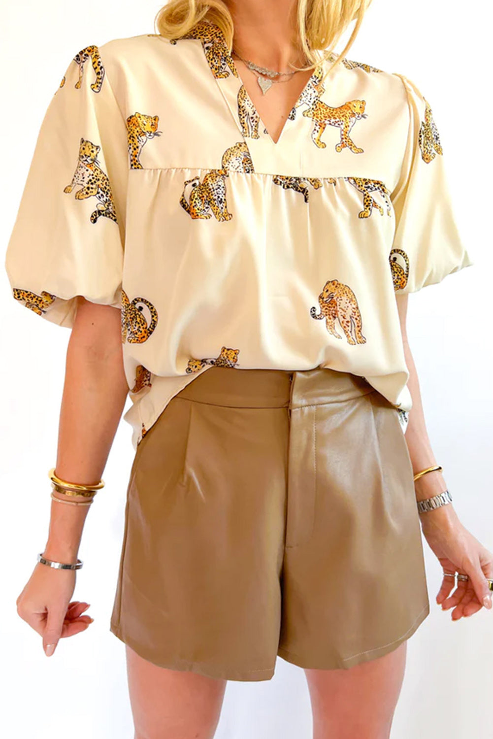 Apricot Animal Print V Neck Puff Sleeve BlouseMaterial:100%Polyester



		The blouse features an animal print pattern, which adds a bold and eye-catching element to the design. 
	
	
		Animal prints, such as