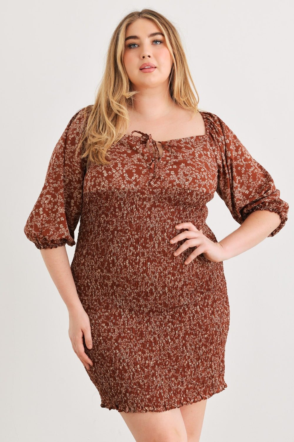 Zenobia Plus Size Smocked Printed Square Neck Mini DressSmocked Printed Square Neck Mini Dress is a trendy and feminine choice for any occasion. The square neckline adds a touch of elegance, while the smocked detailing en