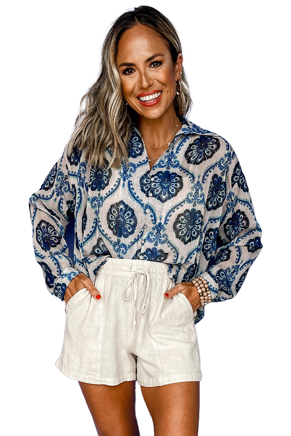 Blue Ethnic Print Button V Neck Loose ShirtMaterial:100%Polyester

• Embrace a blend of cultures with the shirt, featuring a unique blend of bohemian and abstract patterns. 
• Effortlessly stylish with its 