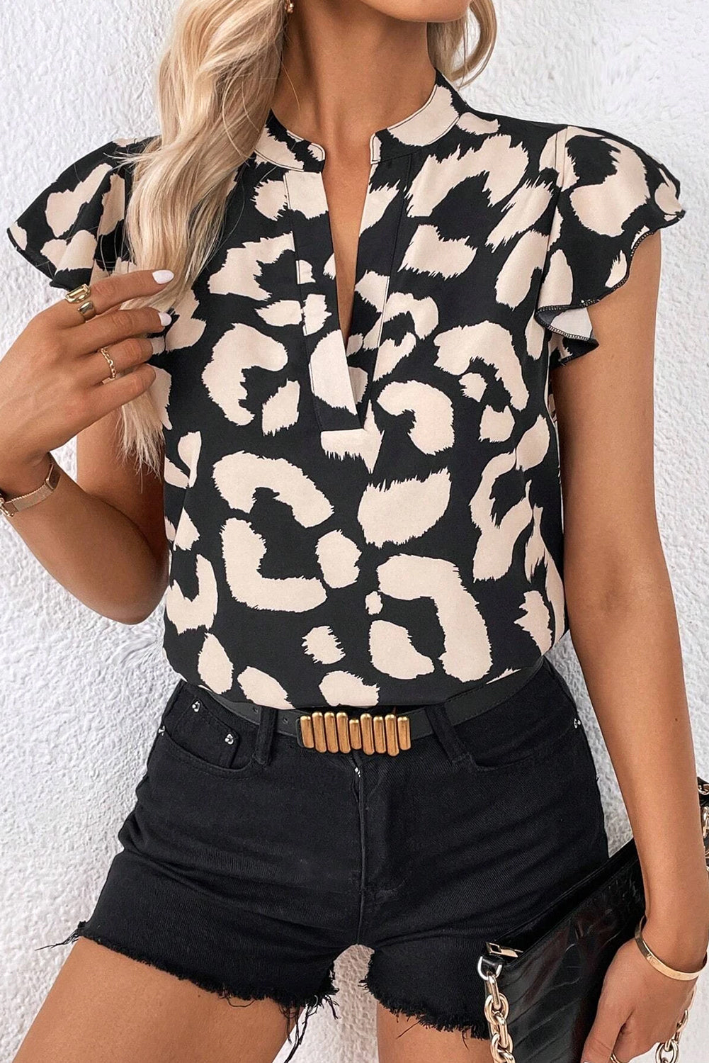 Black Leopard Ruffled Flutter Sleeve Split Neck BlouseMaterial:100%Polyester

• Embrace your wild side with the blouse, perfect for adding a touch of exotic flair to your wardrobe.
• The ruffled detailing along the ne