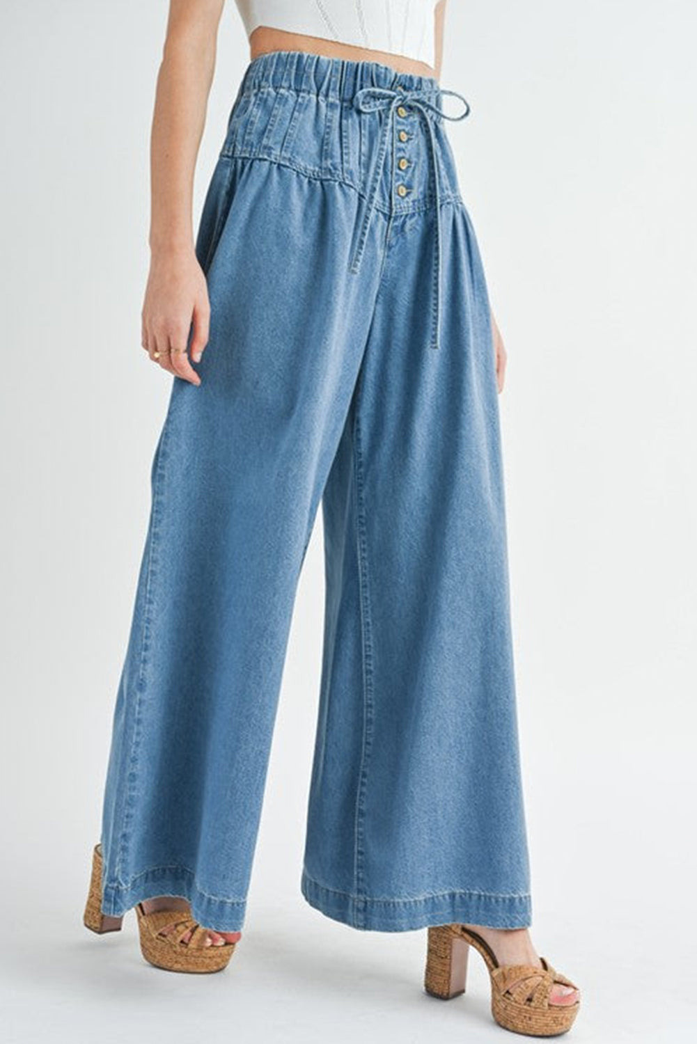 Dusk Blue Mineral Wash Button High Waist Wide Leg JeansMaterial:100%Cotton

• Crafted in a trendy mineral wash, these high waist wide leg jeans exude casual elegance, perfect for a laid-back yet stylish look.
• Featuri