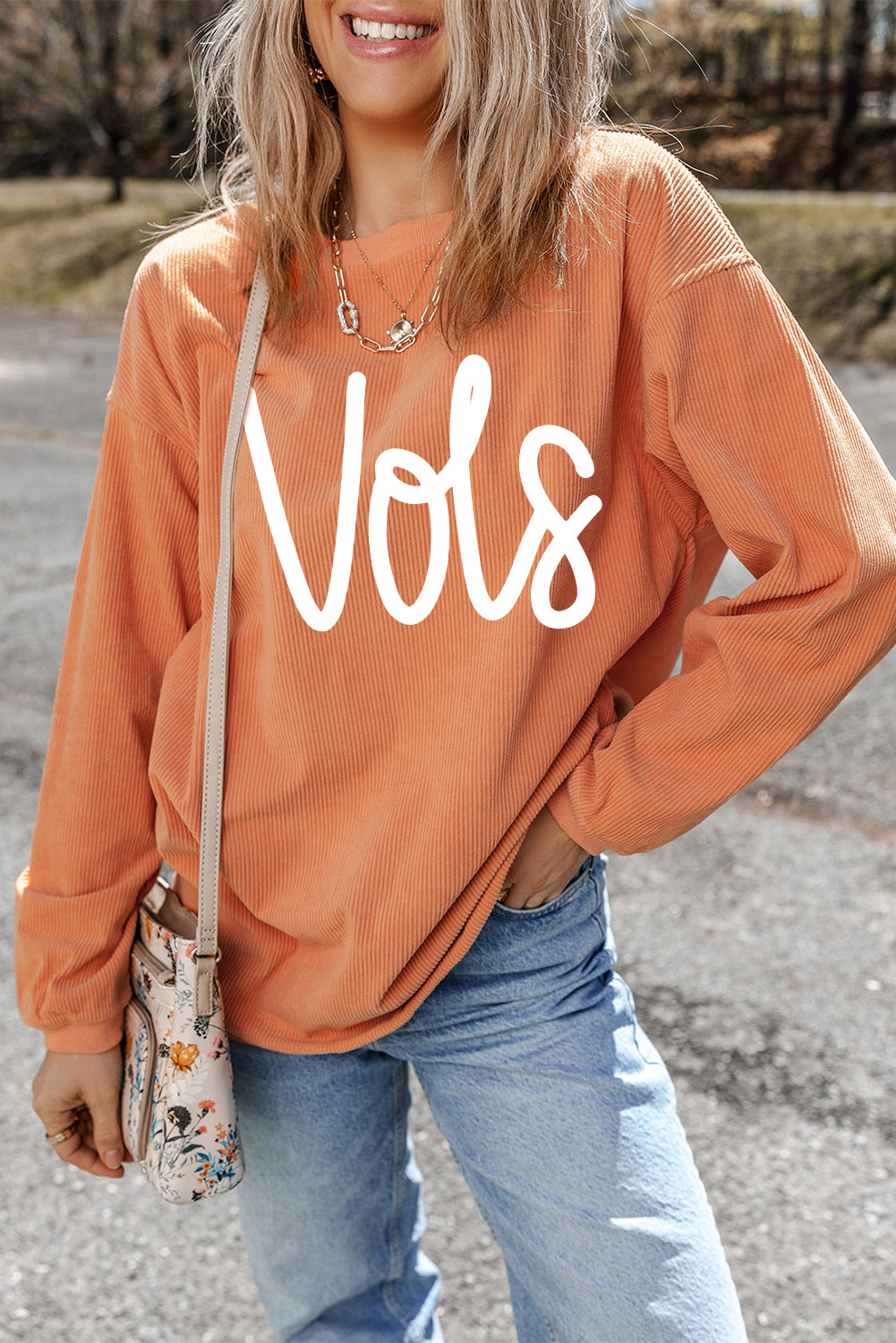 Orange Vols Letter Graphic Crinkle Ribbed Oversized SweatshirtMaterial:100%Polyester

• Vibrant orange hue adds a pop of color to your wardrobe, perfect for standing out in a crowd. 
• Oversized fit provides comfort and a rel