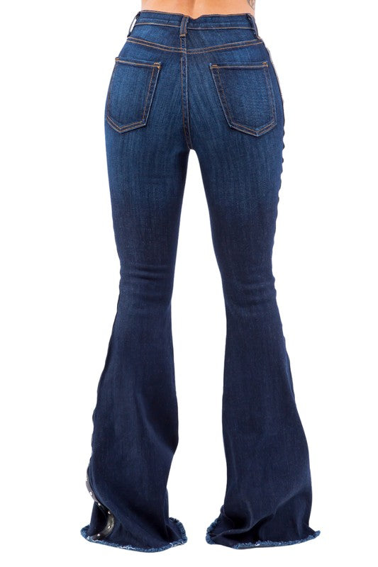 Ropin Bell Bottom Jean- Inseam 32Put on a show with our Ropin' Bell bottom Jean! These jeans have front and back pockets, a front zipper and button, stud accents on the side, and a frayed hem in Dar