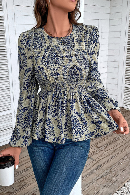 Sky Blue Ethnic Print Balloon Sleeve Smocked Peplum BlouseMaterial:100%Polyester

• Elevate your bohemian style with our blouse, featuring intricate ruffle details for a touch of whimsy.
• The shirred design creates a fla