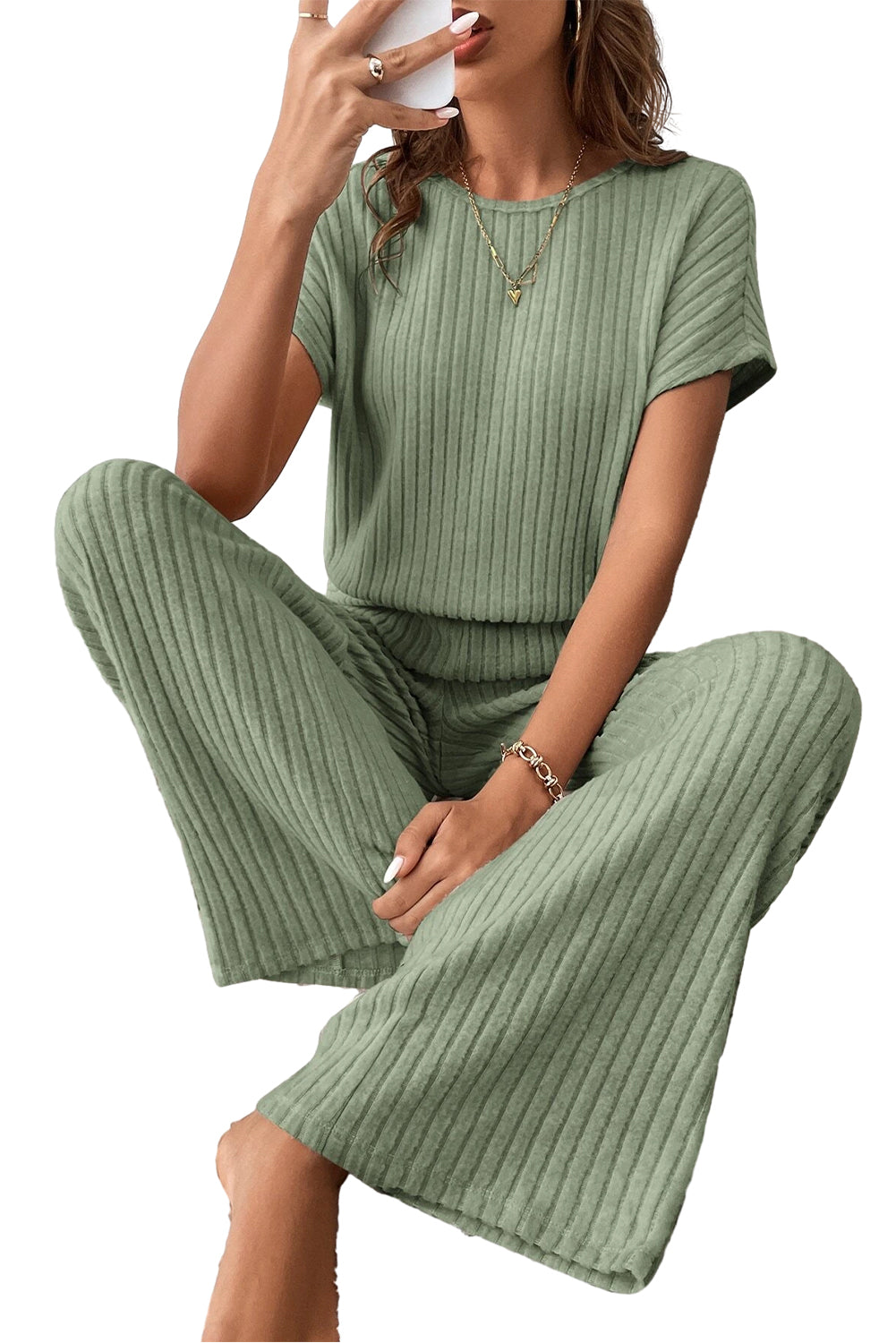 Grass Green Solid Color Ribbed Short Sleeve Wide Leg JumpsuitMaterial:85%Polyester+10%Viscose+5%Elastane



		The jumpsuit is a versatile and trendy one-piece outfit, featuring a solid color design that offers a sleek and mi