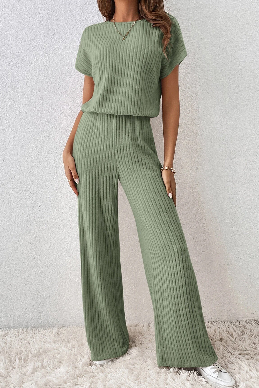 Grass Green Solid Color Ribbed Short Sleeve Wide Leg JumpsuitMaterial:85%Polyester+10%Viscose+5%Elastane



		The jumpsuit is a versatile and trendy one-piece outfit, featuring a solid color design that offers a sleek and mi