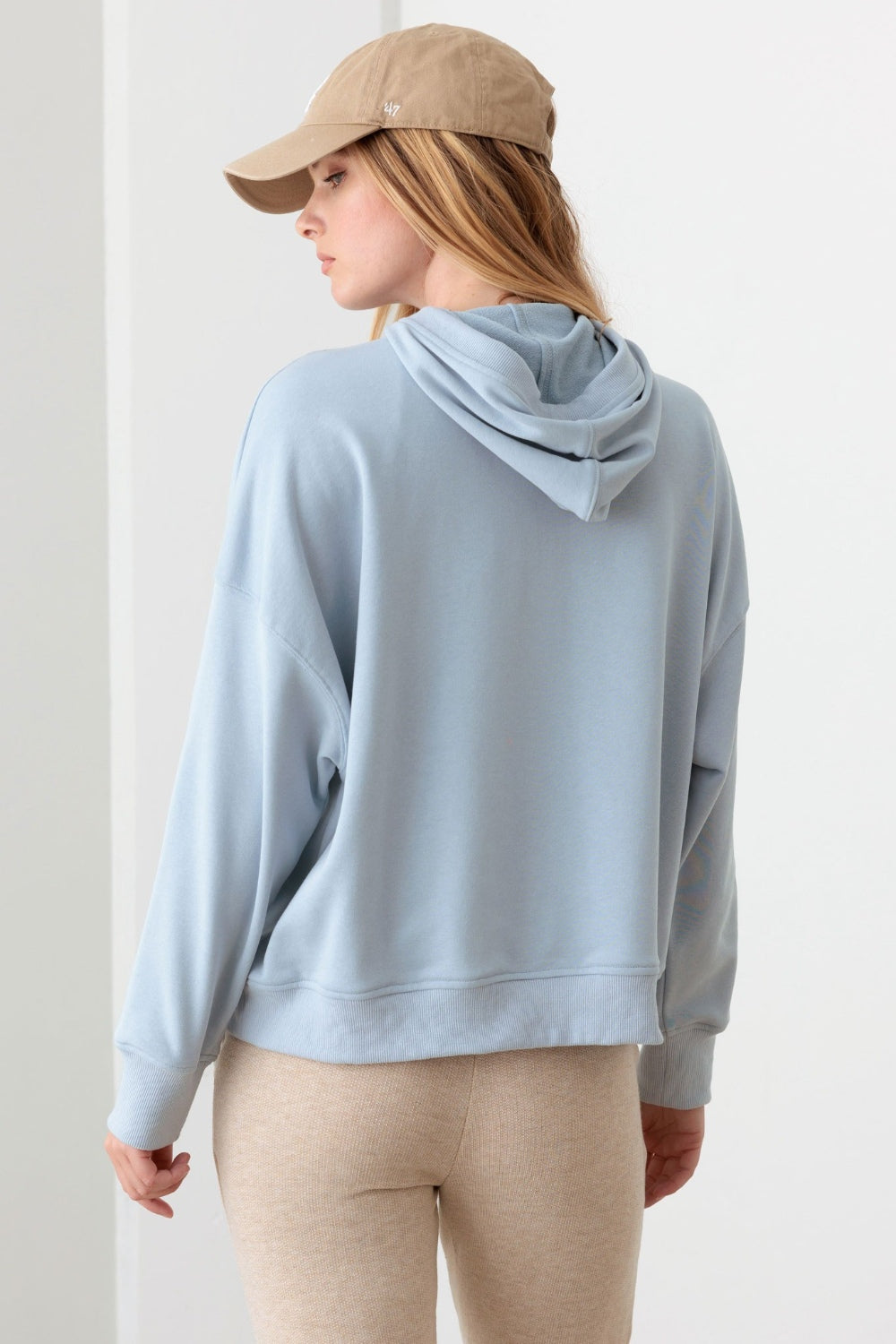 Le Lis Half Zip Drawstring Mock Neck HoodieThe Half Zip Drawstring Mock Neck Hoodie features a solid color design with long sleeves and a front half zipper for easy on and off. The drawstring mock neck adds a