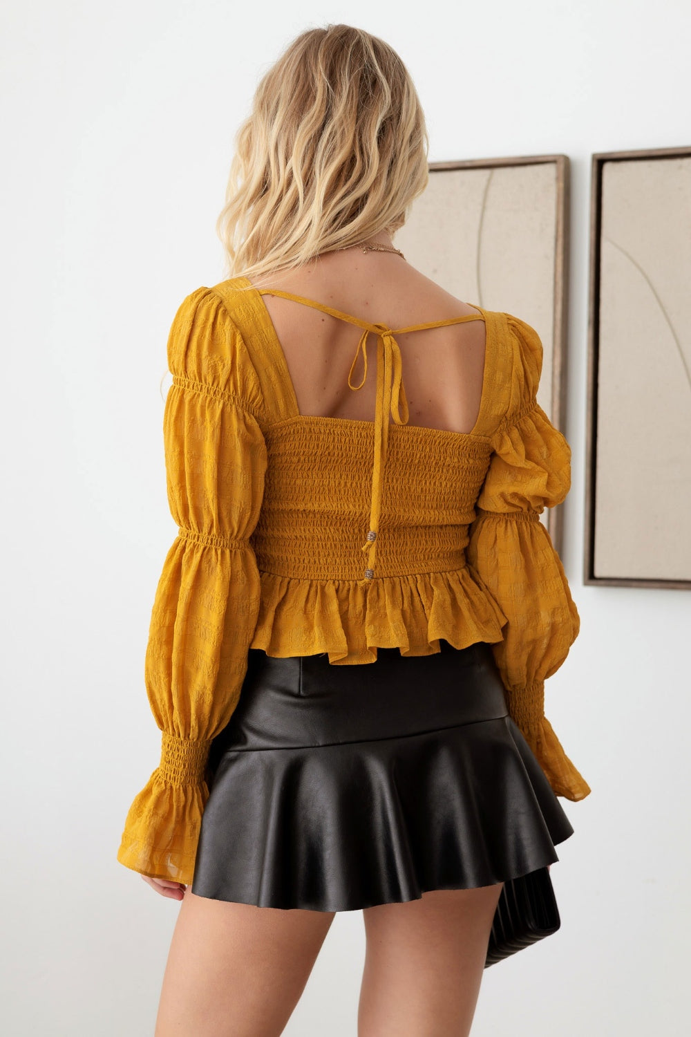 Mustard Seed Boho Shirred Smocked Peplum Long Sleeve TopThis boho shirred smocked peplum long sleeve top is a perfect blend of bohemian and chic style. The shirred detailing adds texture and dimension to the top. The smoc