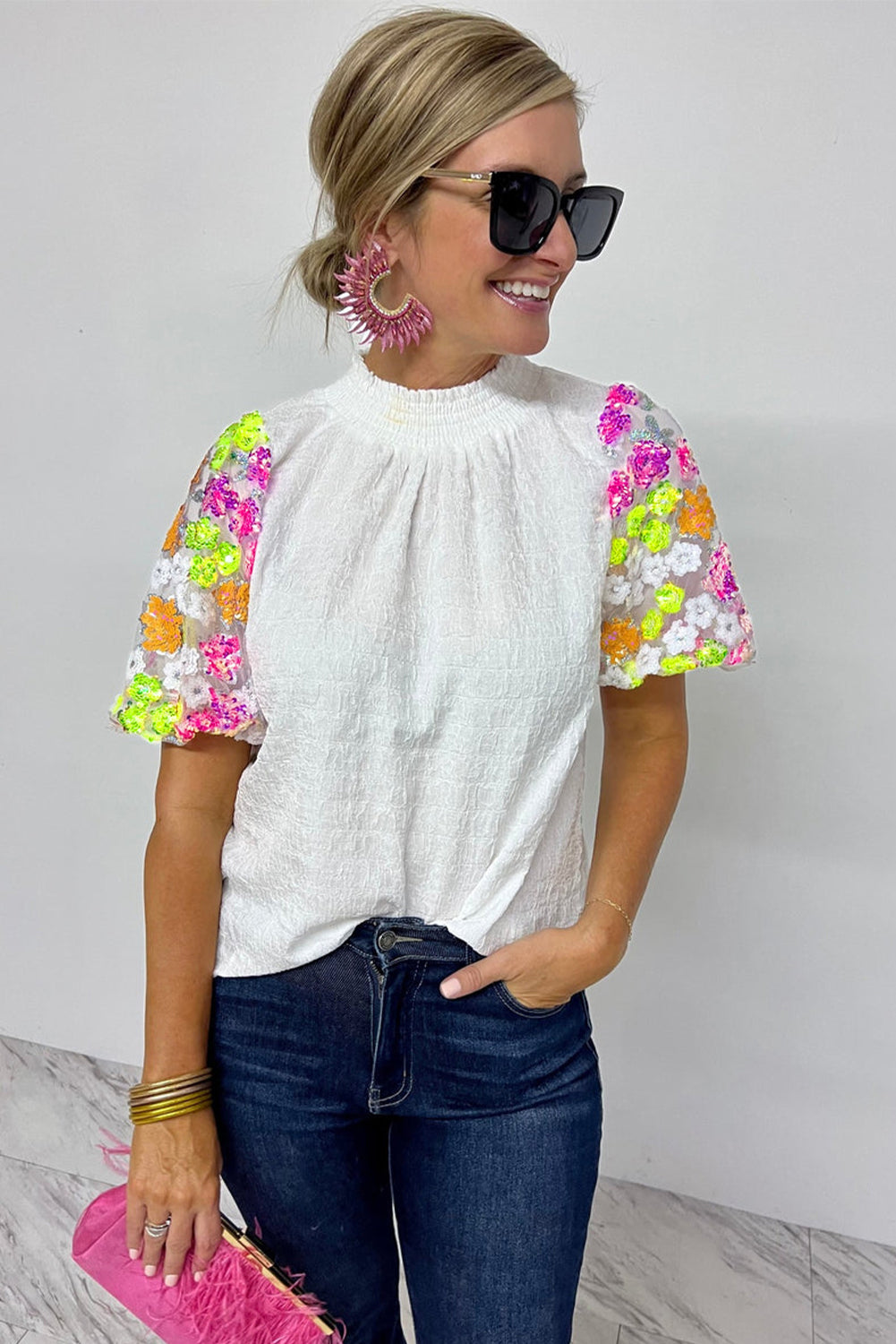 White Smocked Neck Sequin Flower Puff Sleeve Textured TopMaterial:100%Polyester



		The Top features a smocked neckline and sequin flower embellishments for a feminine and glamorous look.
	
	
		With its puff sleeves,