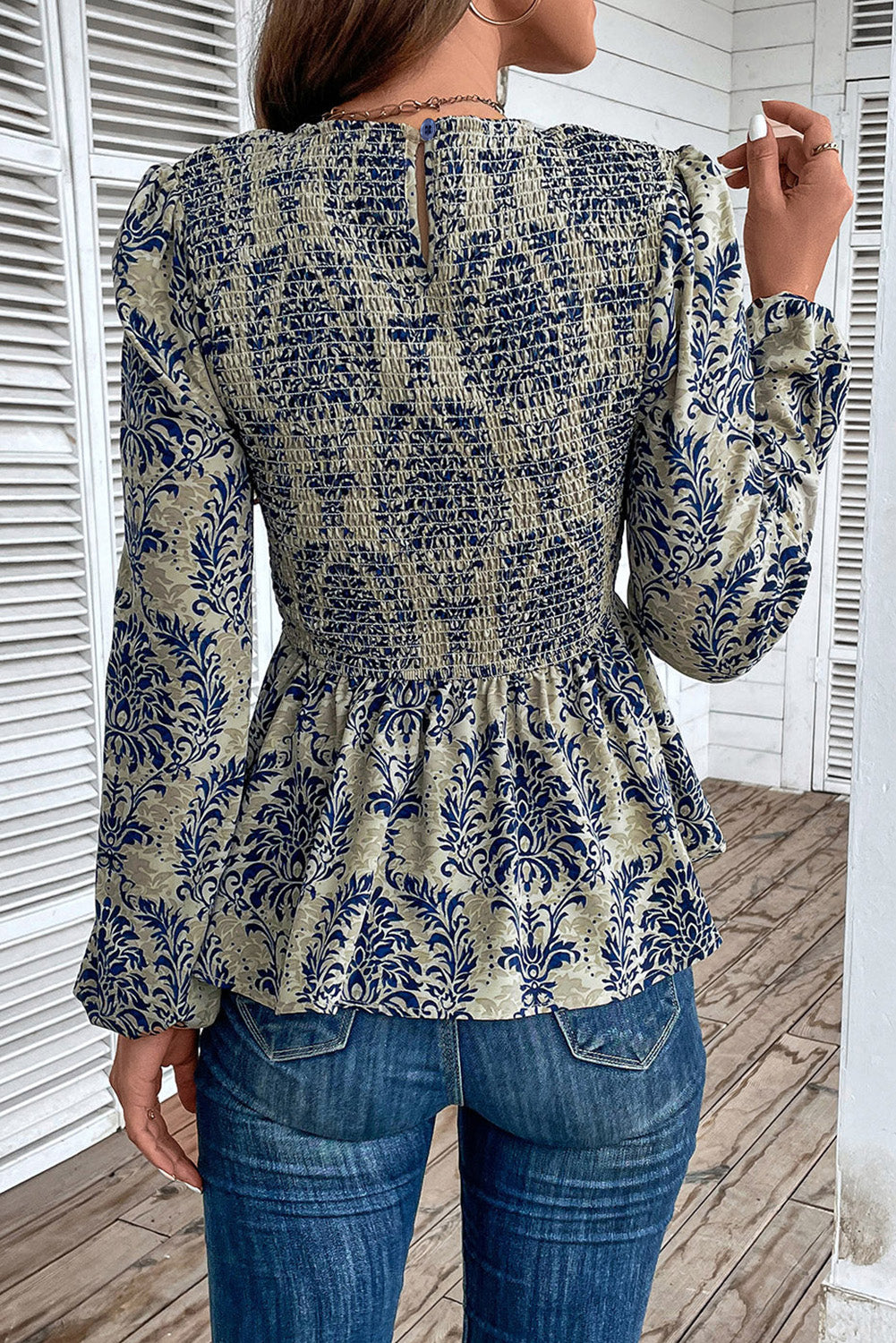 Sky Blue Ethnic Print Balloon Sleeve Smocked Peplum BlouseMaterial:100%Polyester

• Elevate your bohemian style with our blouse, featuring intricate ruffle details for a touch of whimsy.
• The shirred design creates a fla