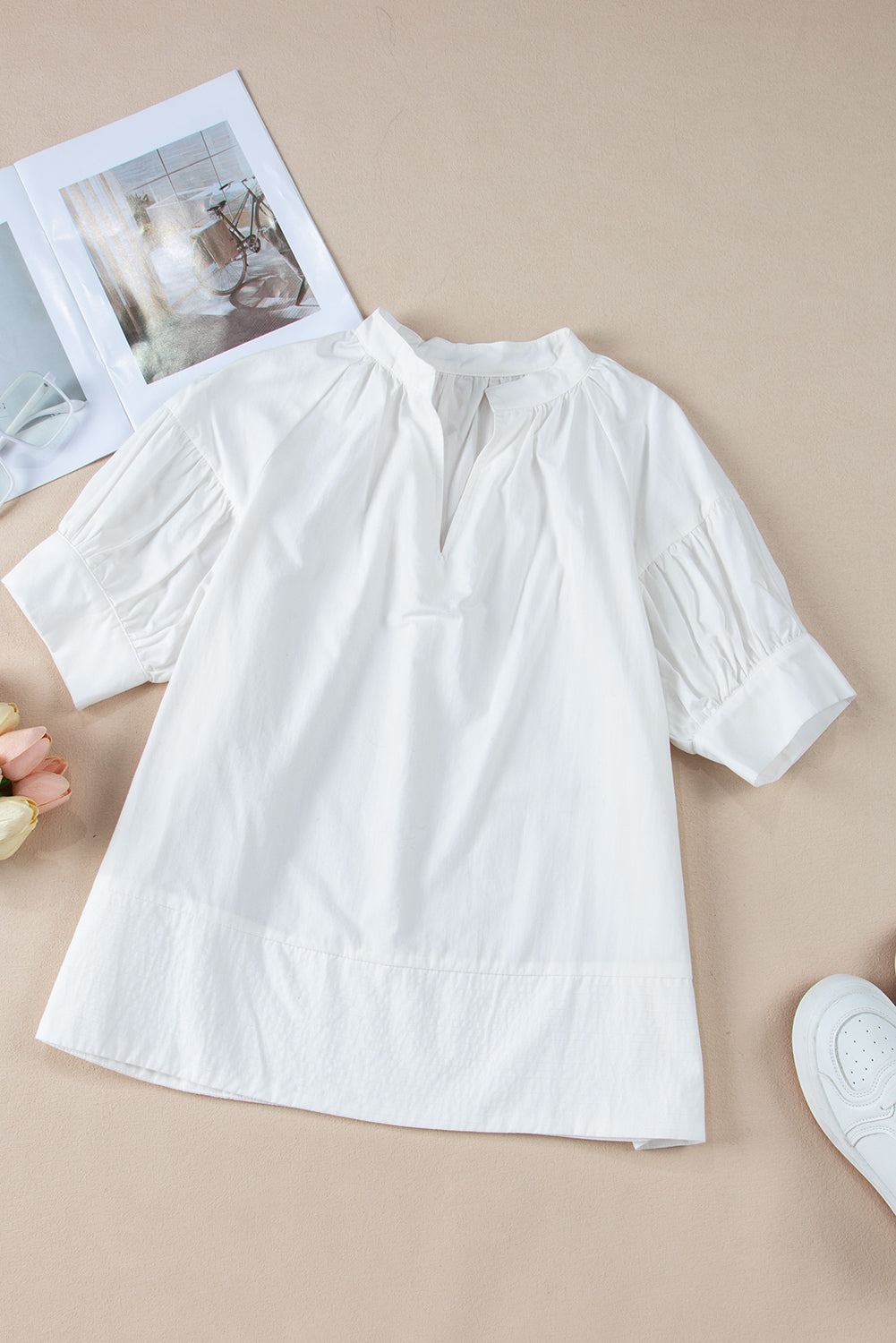 White Solid Color Ruched Bubble Sleeve V Neck ShirtMaterial:100%Cotton

• The ruched detailing on the sleeves adds a touch of texture and visual interest, making this top a standout choice for any occasion. 
• Craf