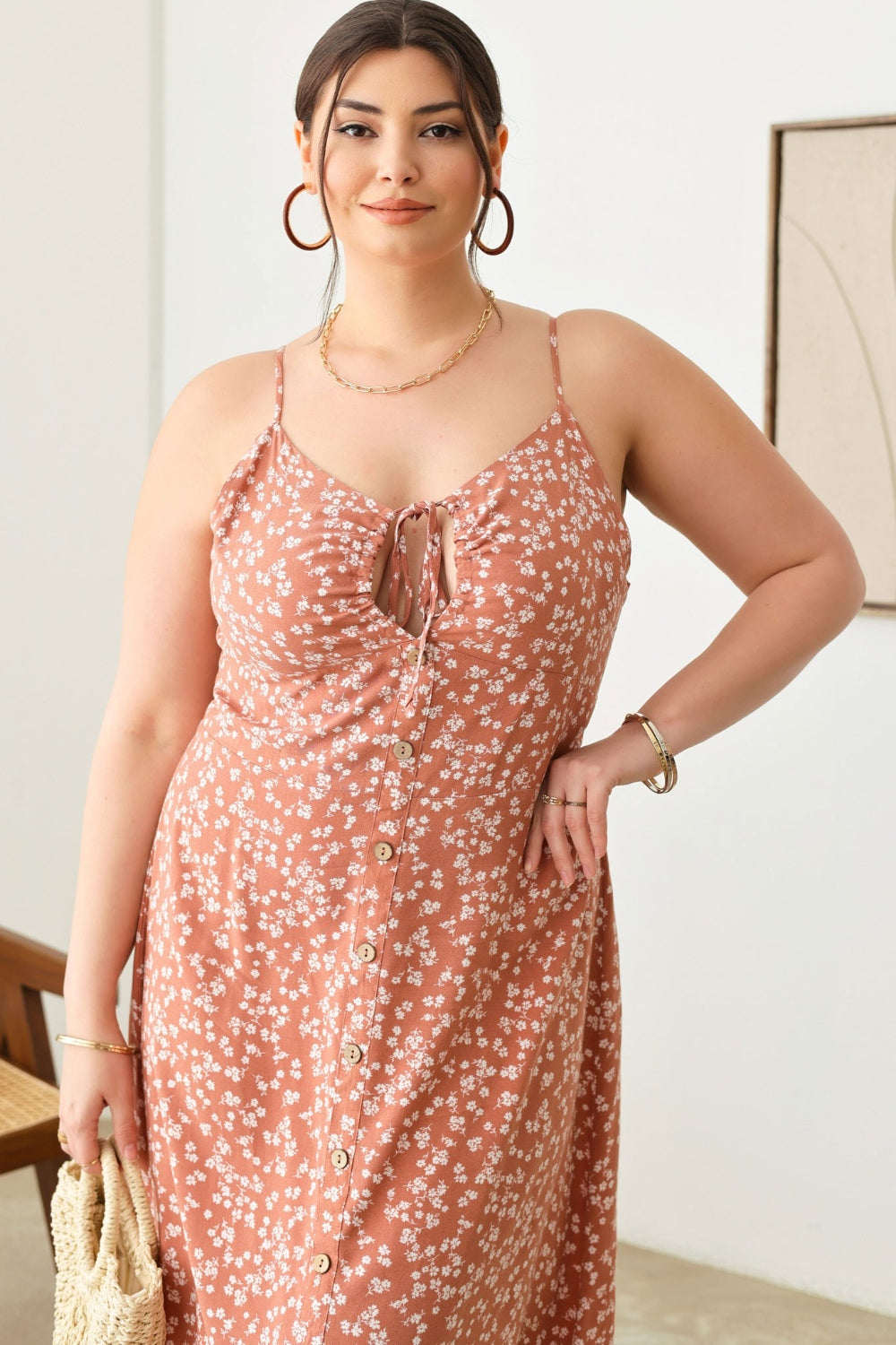 Zenobia Plus Size Cutout Floral Spaghetti Strap DressCutout Floral Spaghetti Strap Dress is a stylish and feminine piece that is perfect for summer outings or special occasions. The cutout design adds a trendy touch, w