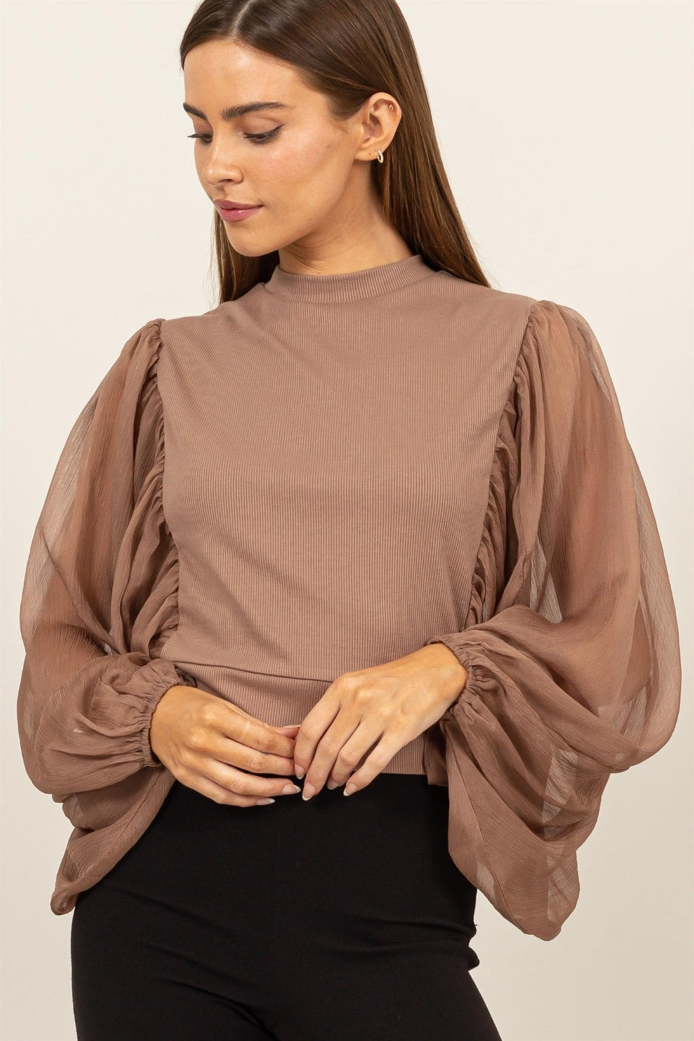 HYFVE Ruched Sheer Long Sleeve Mock Neck BlouseAugment your wardrobe's elegance with this Sheer Sleeve Back Button Blouse. Showcasing delicate sheer sleeves and a sophisticated back button closure, this blouse is