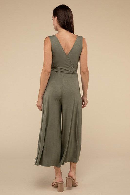 Surplice Neckline Sleeveless JumpsuitThe Surplice Neckline Sleeveless Jumpsuit exudes effortless elegance and modern sophistication. Featuring a surplice neckline, this jumpsuit offers a chic and flatte