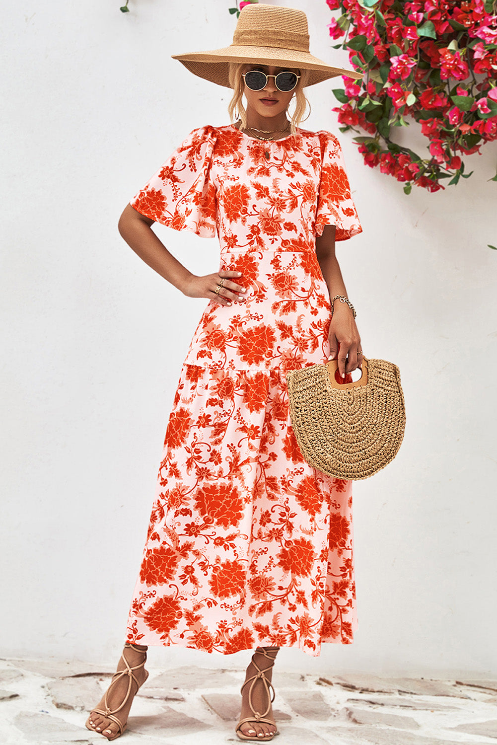 Orange Floral Print Knotted Back Round Neck Maxi Dress• Embrace the vibrant energy of summer with this dress, featuring a charming knotted back detail for a touch of elegance.
• Effortlessly chic, this dress boasts a r