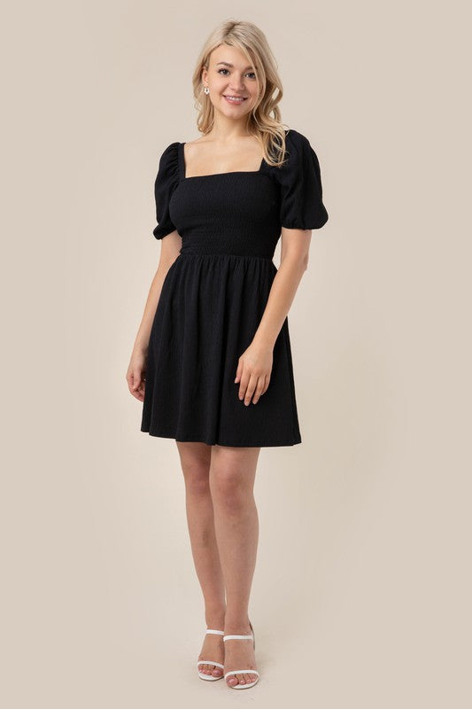 Puff sleeved smocked dress- Puff sleeved smocked dress- Pattern type : solid- Neck line : square neck- Sleeve type : puff sleeves- Sleeve length : short sleeves- Stretch : stretch- Sheer : no