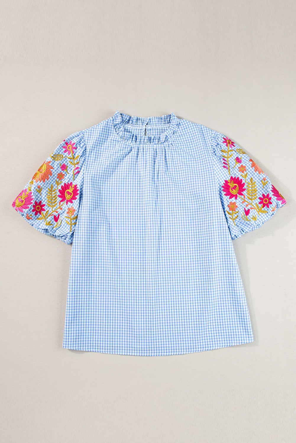 Light Blue Flower Embroidered Puff Sleeve Gingham BlouseMaterial:100%Cotton

• Elevate your casual look with our blouse, featuring intricate floral embroidery on a classic gingham pattern.
• The puff sleeves add a touch