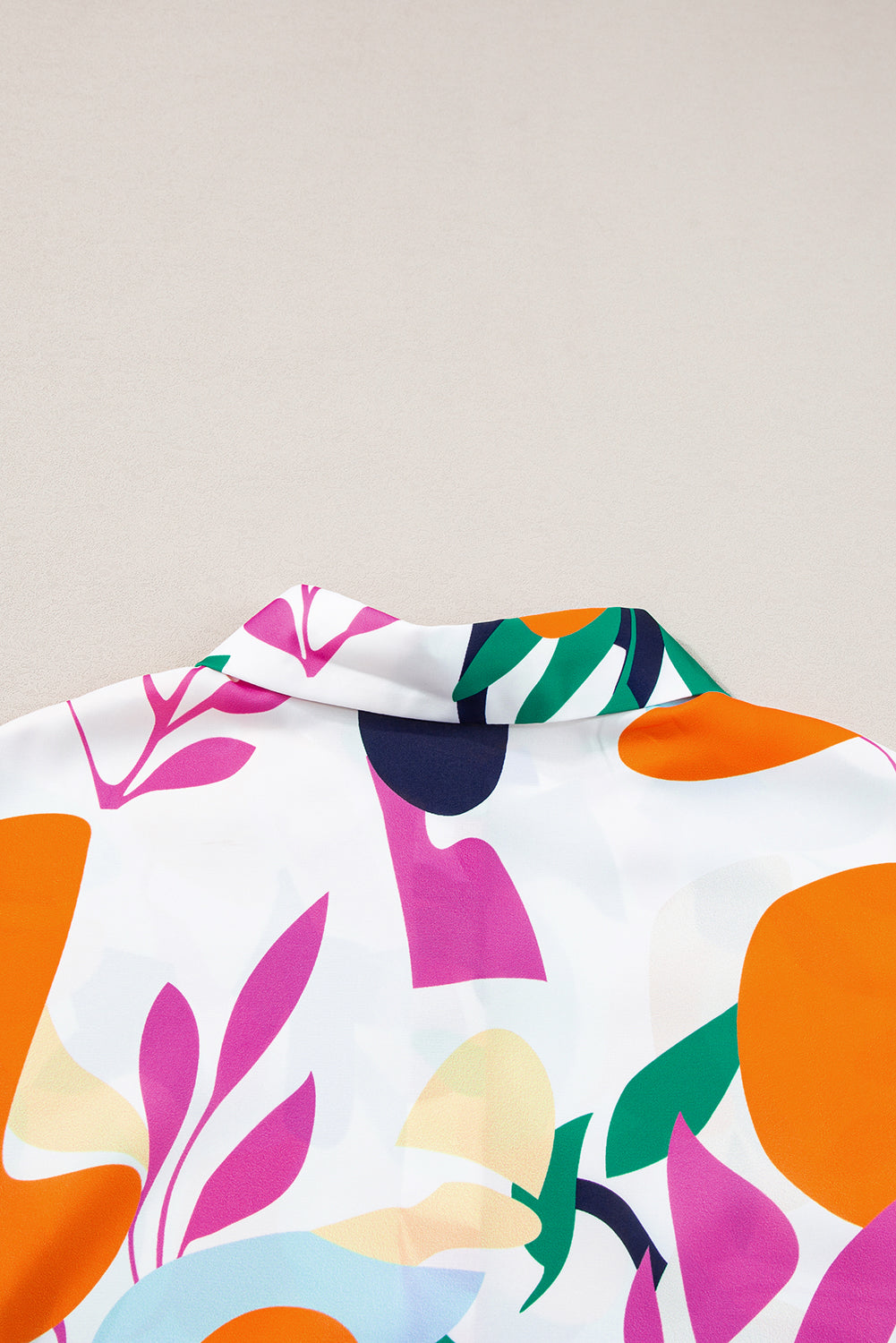 Multicolour Abstract Leaf Print Button Up Short Sleeve BlouseMaterial:100%Polyester

• Infuse your wardrobe with vibrancy in this blouse, perfect for a relaxed yet stylish look.
• The button-up design adds a touch of sophist