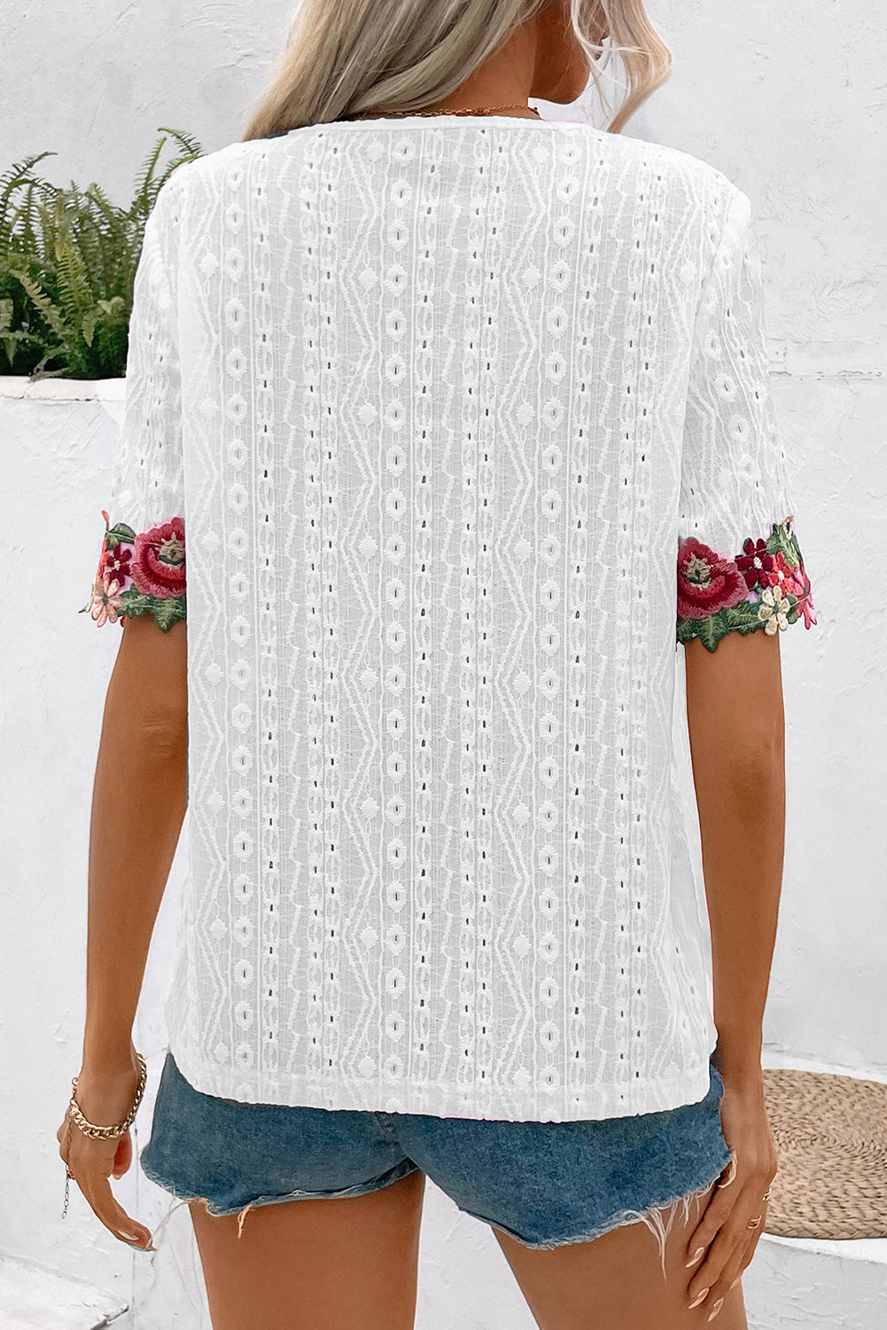 White V-Neck Floral Embroidered Trim Eyelet Blouse• Elevate your summer wardrobe with this blouse featuring intricate Floral Embroidered Trim for a touch of bohemian charm.
• The delicate Eyelet Lace detailing adds