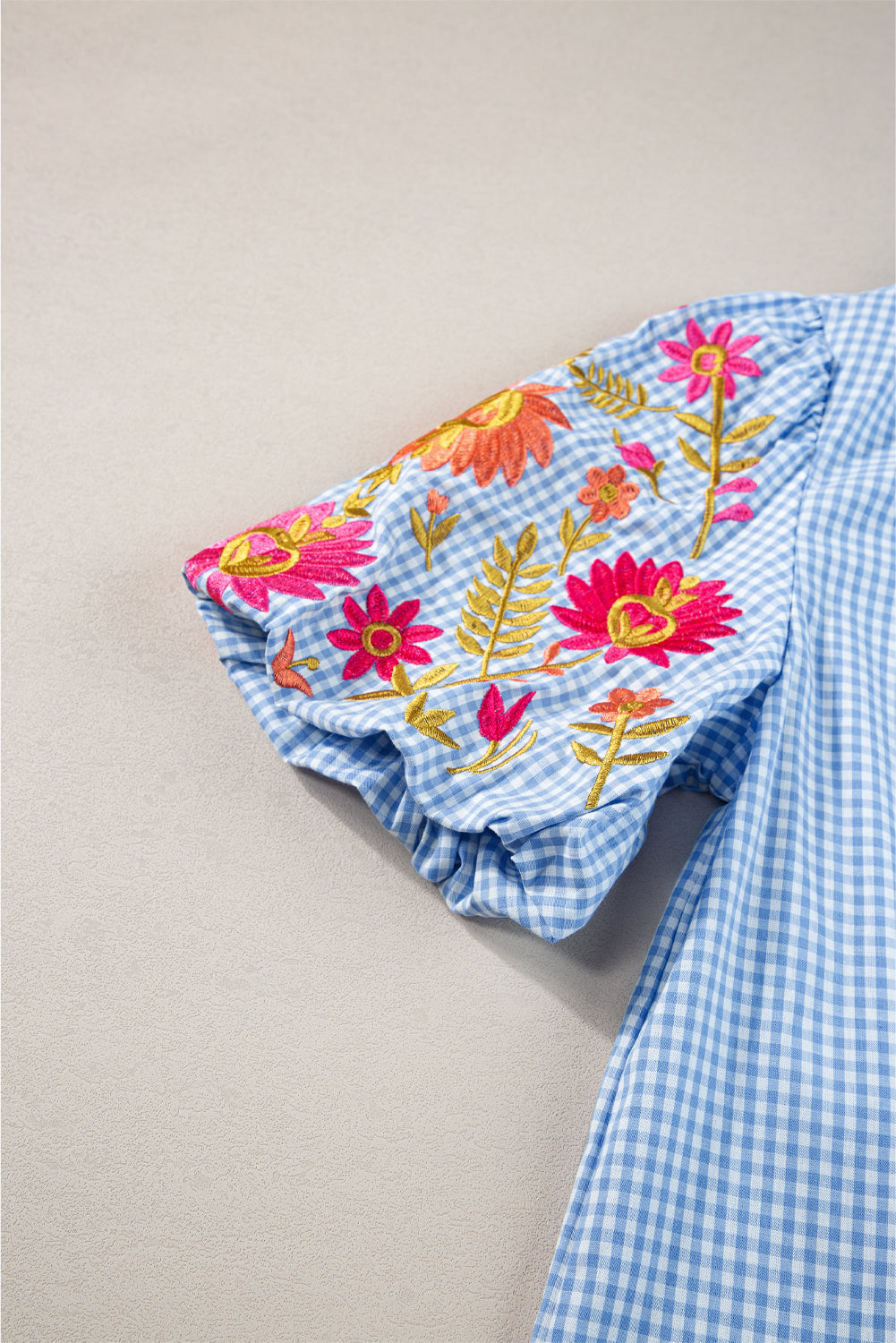 Light Blue Flower Embroidered Puff Sleeve Gingham BlouseMaterial:100%Cotton

• Elevate your casual look with our blouse, featuring intricate floral embroidery on a classic gingham pattern.
• The puff sleeves add a touch