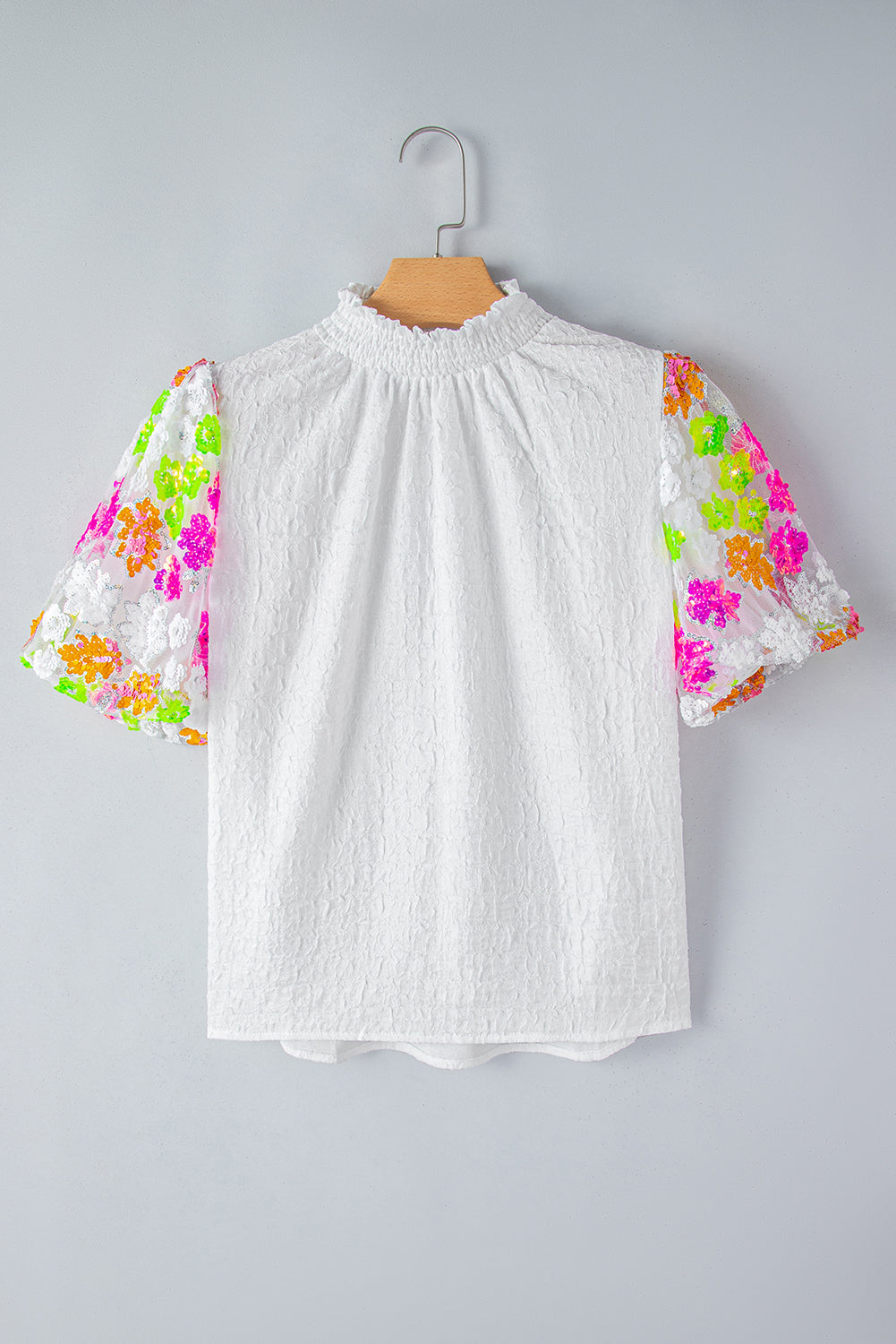 White Smocked Neck Sequin Flower Puff Sleeve Textured TopMaterial:100%Polyester



		The Top features a smocked neckline and sequin flower embellishments for a feminine and glamorous look.
	
	
		With its puff sleeves,