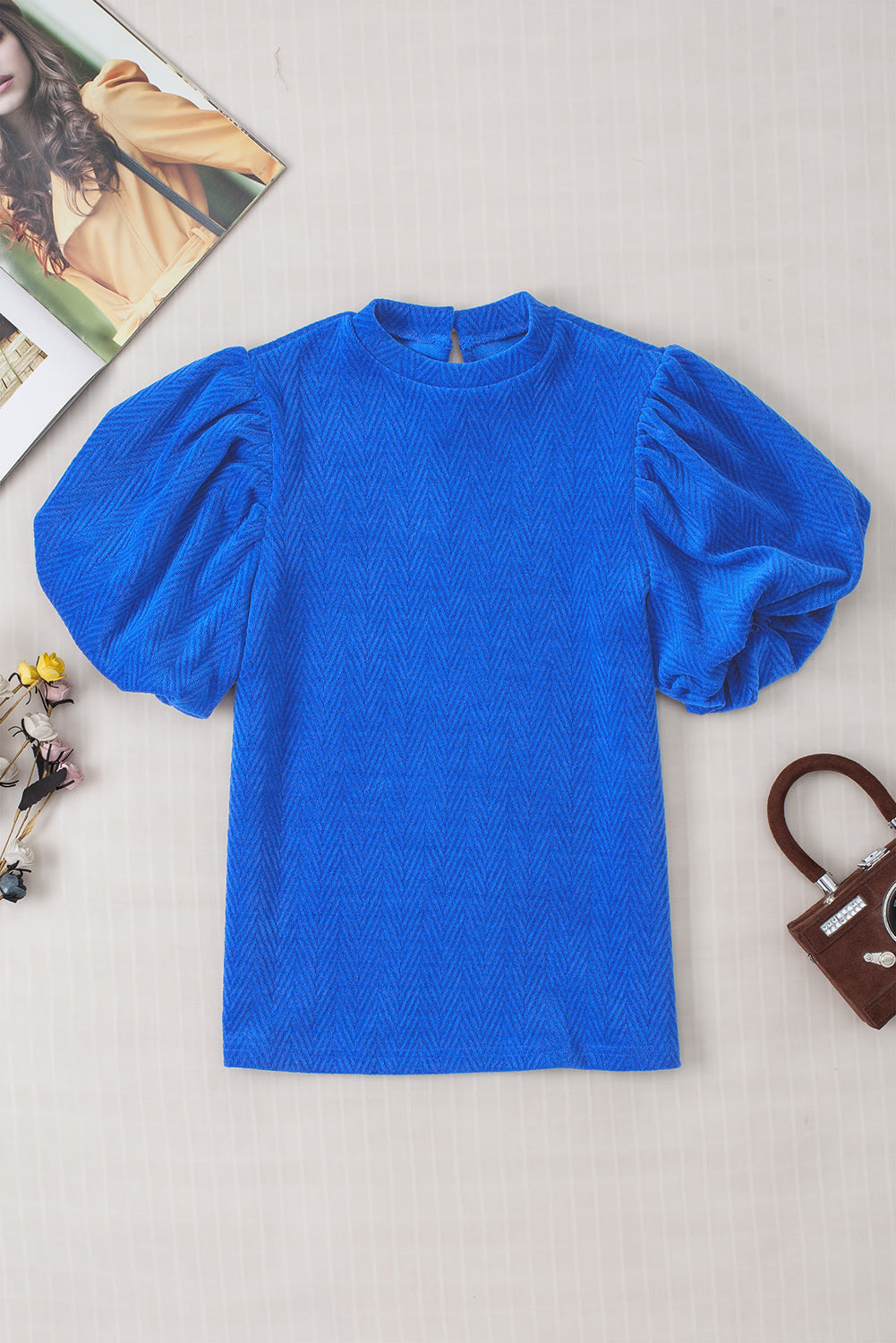 Sky Blue Solid Textured Puff Sleeve Mock Neck BlouseMaterial:97%Polyester+3%Elastane



		This sky blue blouse features a solid textured design with puff sleeves and a mock neck. 
	
	
		The textured fabric adds v